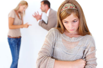 Photo of couple arguing in front of teenage daughter